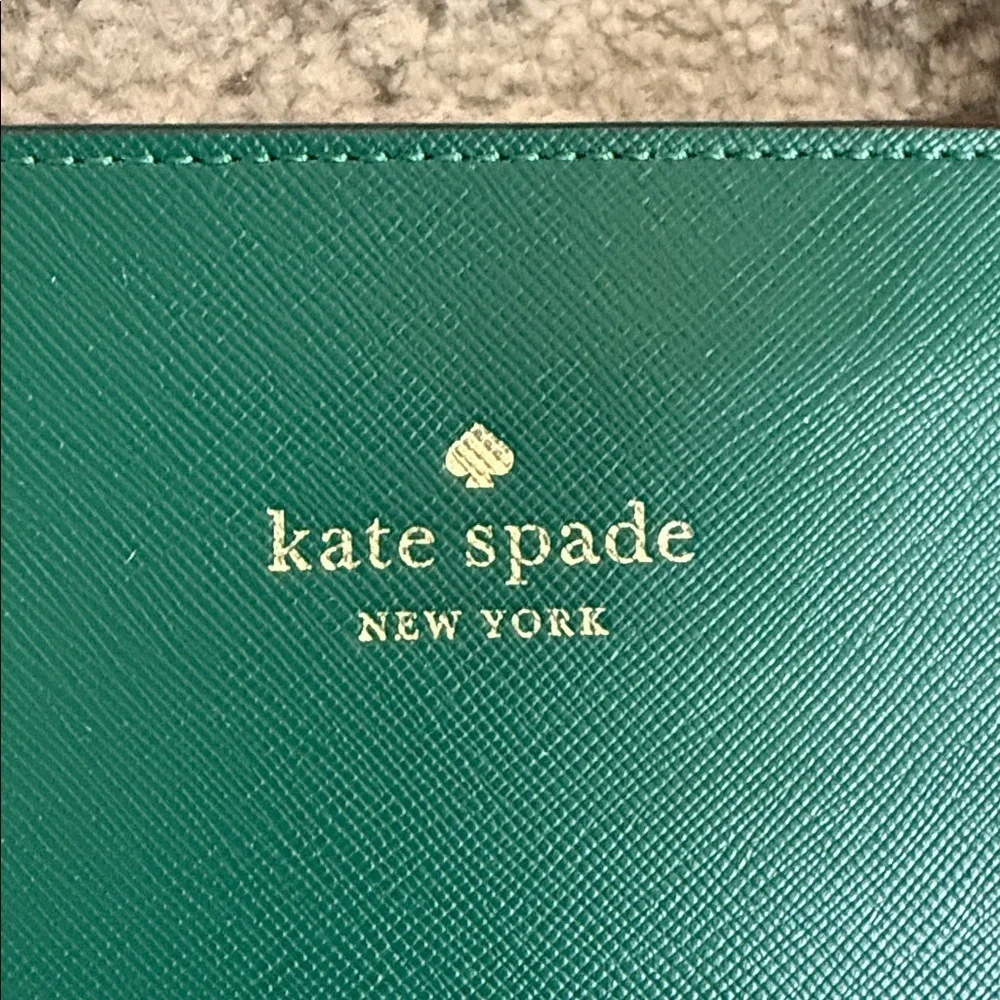 Kate Spade Brynn leather tote bag in the deep jade color with bow charm
